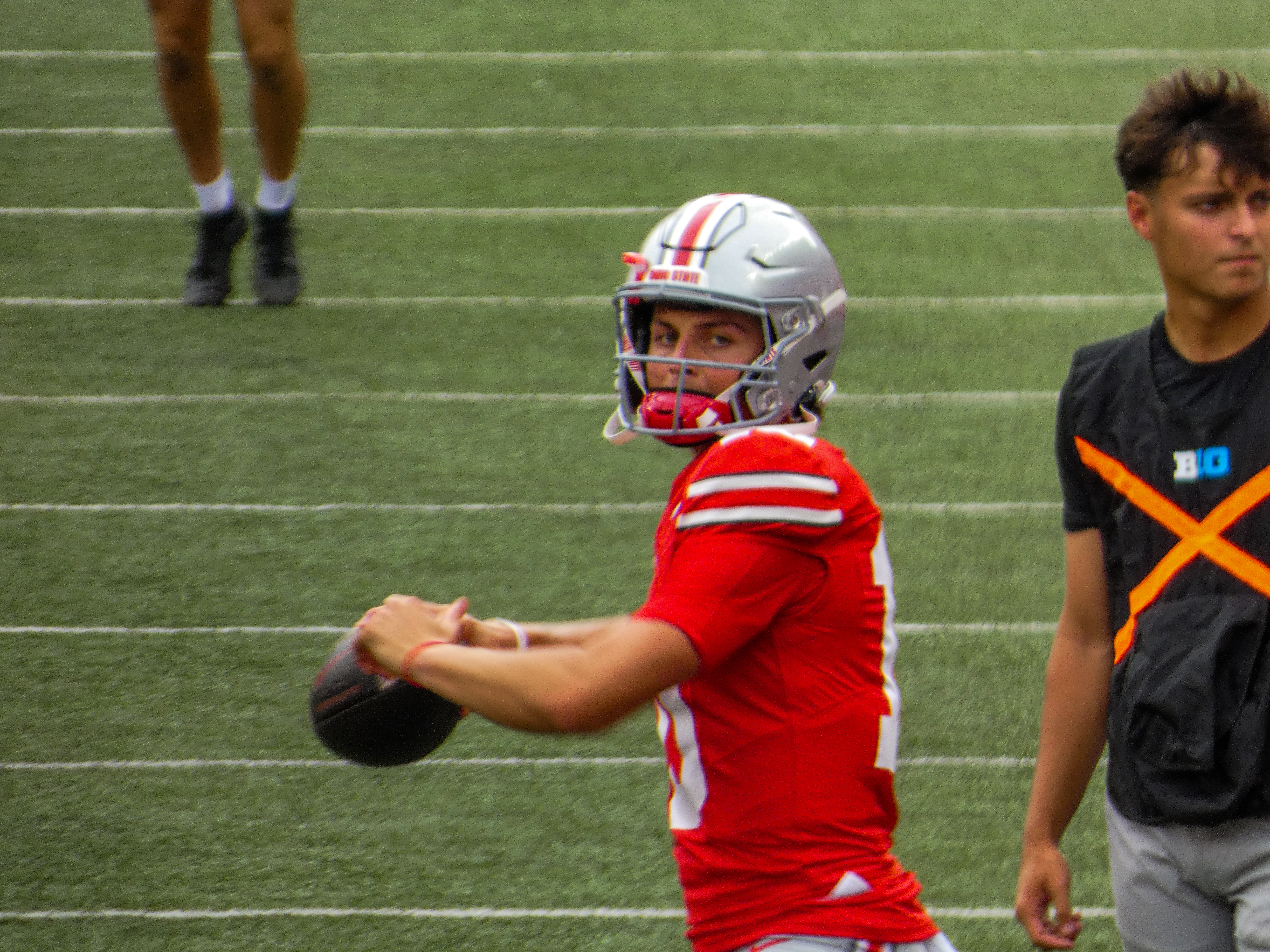 Ohio State quarterback Julian Sayin holding a football during pregame warmups in 2024.