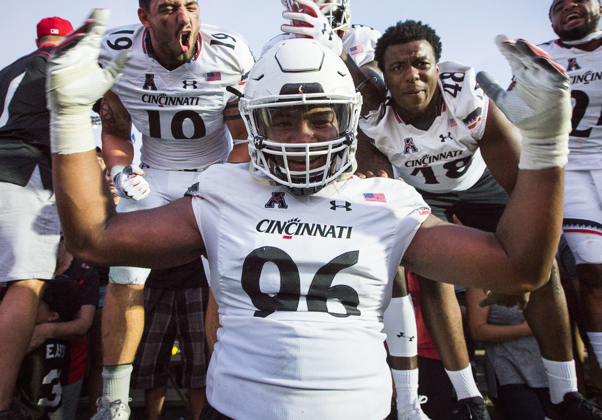 Cincinnati Bearcats defensive tackle Cortez Broughton celebrates with teammates after defeating UCLA in 2018.