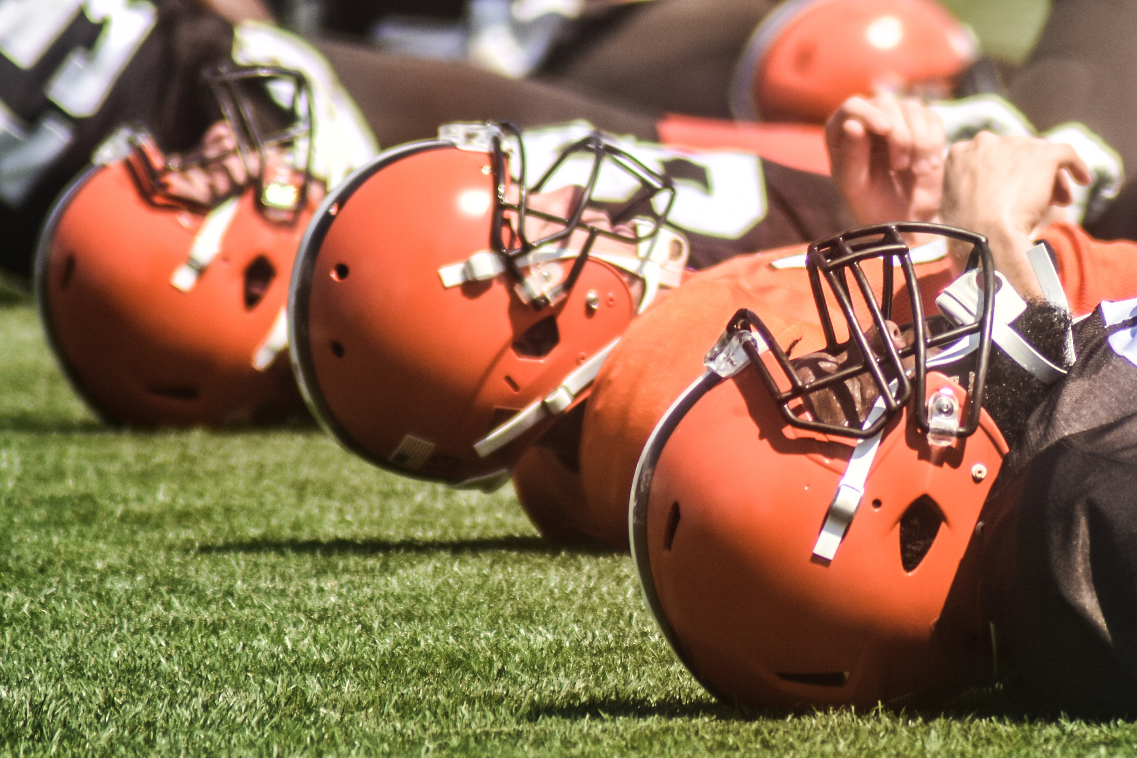 Several Cleveland Browns helmets rest on the practice field during 2016 training camp.